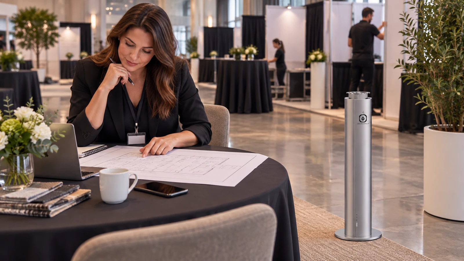 Event planner reviewing a floor sketch near a silver H200D